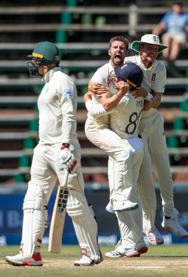 England bowler Mark Wood celebrates with teammates after dismissing Rassie van der Dussen. AP