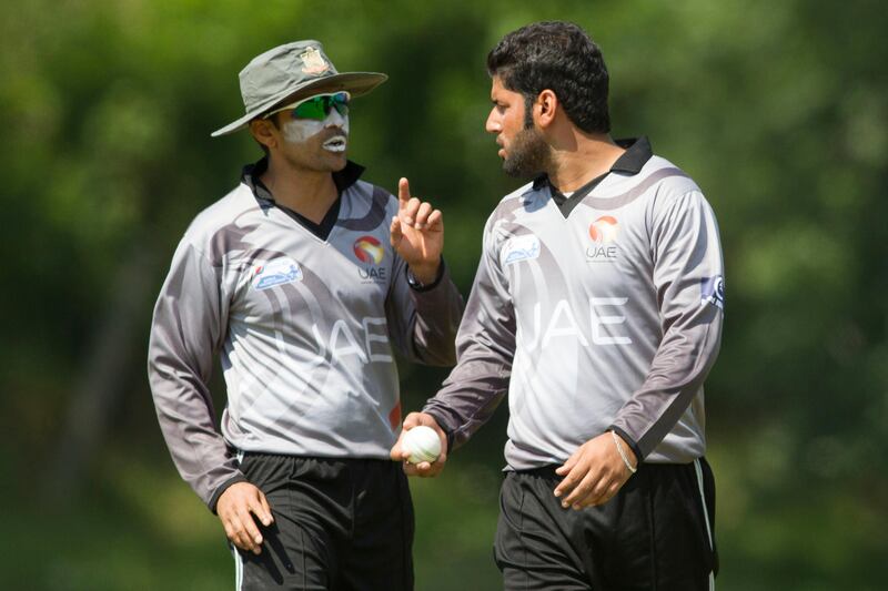 KING CITY, CANADA : August 6, 2013 UAE captain Khurram Khan (left) speaks with Muhammad Naveed as he prepares to bowl against  Canada during the one day international  at the Maple Leaf Cricket club in King City, Ontario, Canada ( Chris Young/ The National). For Sports *** Local Caption ***  chy204.jpg