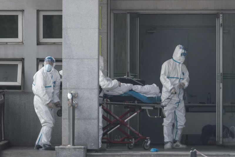 Medical staff carry a patient into the Jinyintan hospital, where patients infected with a new strain of Coronavirus identified as the cause of the Wuhan pneumonia outbreak are being treated, in Wuhan, China.  EPA