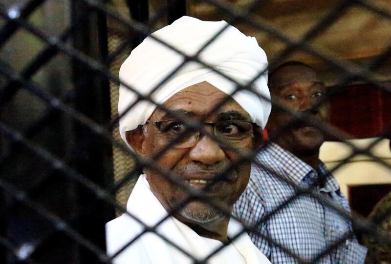 Sudan's former president Omar Hassan al-Bashir smiles as he is seen inside a cage at the courthouse where he is facing corruption charges, in Khartoum, Sudan August 31, 2019. REUTERS/Mohamed Nureldin Abdallah