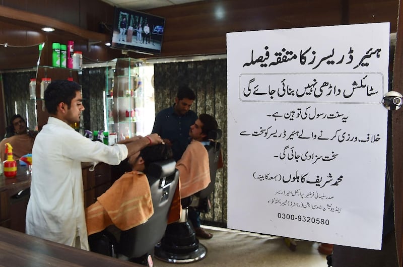 Pakistani hairdressers work at their stations beside a notice sign of the the Sulemani Hairdressers Association that reads "All hairdressers by unanimous decision have decided not to offer their services for clients wishing for stylish beards. It is an insult of Sunnah of Prophet. Violators will be given a harsh punishment", in Peshawar on March 6, 2018. 


Hairdressers in Pakistan's conservative northwest have announced a ban in their shops on "fashionable" beards, saying trendy facial hair violates Islamic law. 
The decision affecting Khyber Pakhtunkhwa province echoes a similar ban introduced there more than a decade ago, after militant groups including the Pakistani Taliban threatened barbers with dire consequences for trimming beards. "Creating different beard designs is against the Sunnah (teachings) of the Prophet Mohammed," Sulemani Hairdressers Association president Sharif Kahlu told a press conference in the provincial capital Peshawar on March 5.
Hairdressers in Pakistan's conservative northwest have announced a ban in their shops on "fashionable" beards, saying trendy facial hair violates Islamic law. The decision affecting Khyber Pakhtunkhwa province echoes a similar ban introduced there more than a decade ago, after militant groups including the Pakistani Taliban threatened barbers with dire consequences for trimming beards. / AFP PHOTO / ABDUL MAJEED