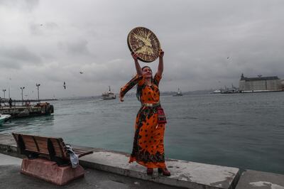 epa09057077 A Kurdish woman holds traditional instrument as she poses for her friend during a demonstration on the occasion of the International Day for the Elimination of Violence Against Women in Istanbul, Turkey, 06 March 2021. The International Day for the Elimination of Violence Against Women is an effort to raise awareness of the fact that women around the world are subject to rape, domestic violence and other forms of violence. According to the 'We'll Stop Femicide' social platform, 335 women were killed through gender violence and hundreds assaulted by men in 2020, in Turkey.  EPA/SEDAT SUNA