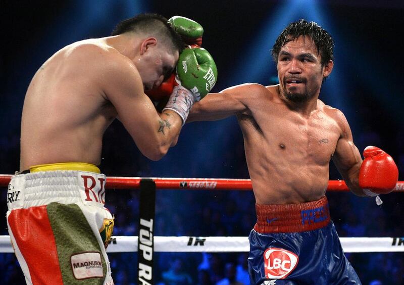 Manny Pacquiao of the Philippines competes against Brandon Rios of the US during a welterweight boxing bout in Macau on November 24, 2013. AFP PHOTO / Dale de la Rey