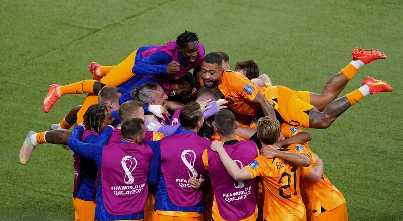 Netherlands' Daley Blind is mobbed by teammates. PA