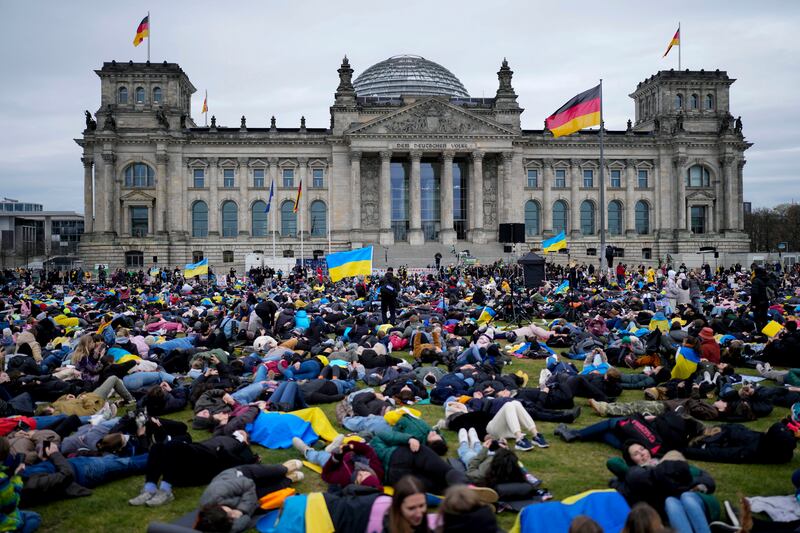 Demonstrators lie down on the ground in tribute to the people killed in Russia's war against Ukraine, in Berlin, Germany. AP