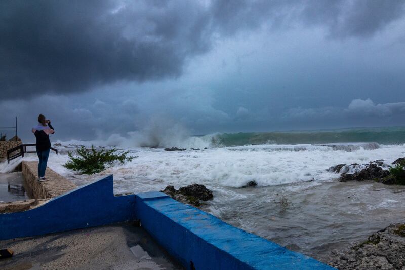 Photographing the crashing waves as Hurricane Ian tears through George Town, Grand Cayman. AP Photo