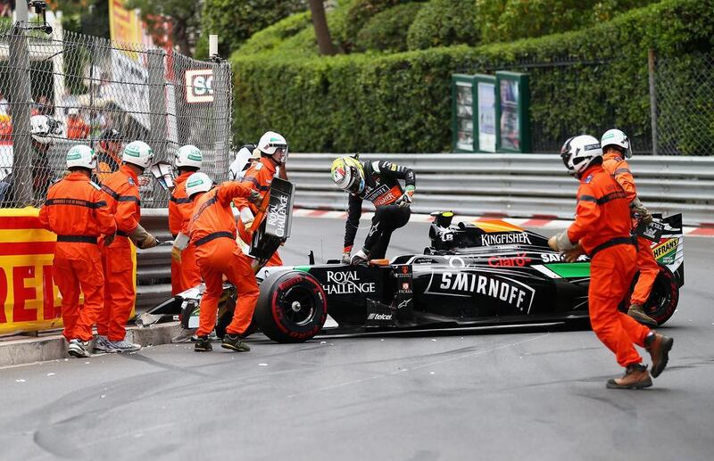 Force India driver Sergio Perez climbs out of his car after crashing at the Monaco Grand Prix on Sunday. Clive Mason / Getty Images / May 25, 2014