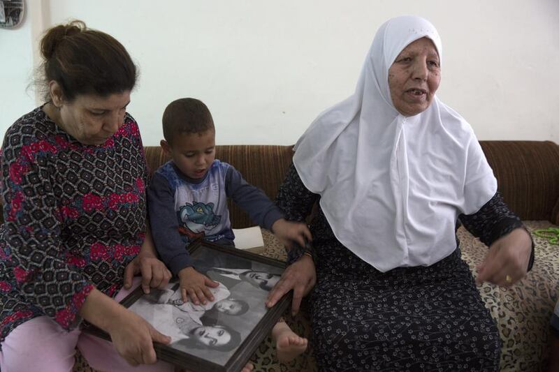 Zulfa Omar Mughrabi, 77, sitting with her grandson and other family members in their home in the Palestinian East Jerusalem neighbourhood of Beit Hanina, still remembers the demolition of the Moroccan Quarter. She said that her family was the last to leave the Moroccan Quarter. Heidi Levine for The National