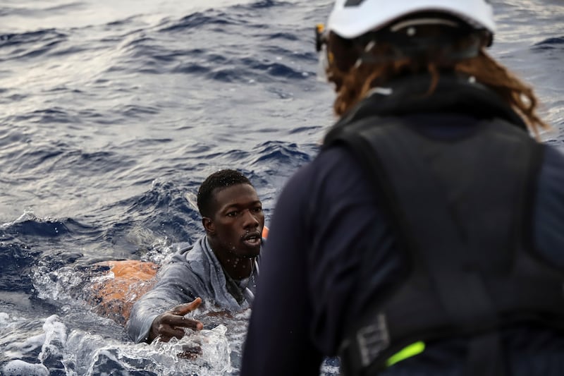 A migrant is rescued from the water.