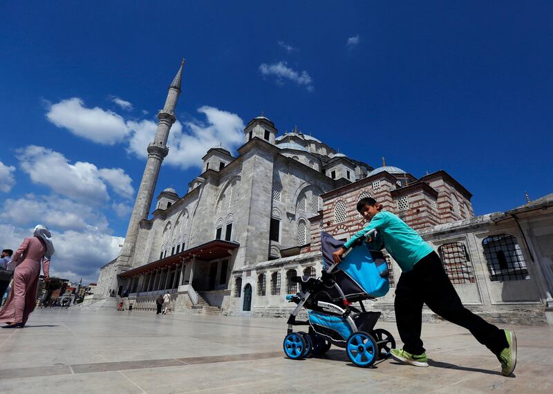 A Syrian boy pushes a pram past Fatih mosque in Istanbul. Syrians say Turkey has been detaining and forcing some Syrian refugees to return back to their country the past month. The expulsions reflect increasing anti-refugee sentiment in Turkey, which opened its doors to millions of Syrians fleeing their country's civil war.  AP Photo