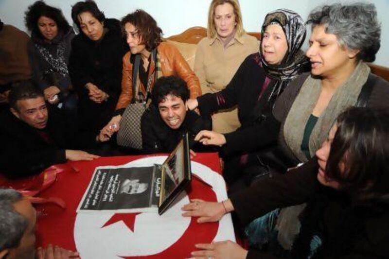 Basma Khalfaoui Belaid (second from right), the widow of slain Tunisian opposition leader Chokri Belaid, cries with relatives around her husband’s coffin in Tunis.