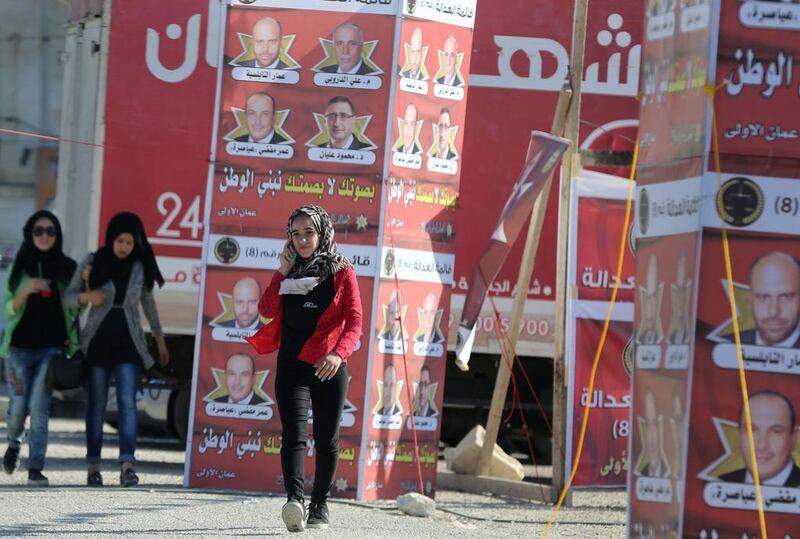 Young women in Amman walk past campaign posters for Jordan’s  parliamentary elections on September 20, 2016. Khalil Mazraawi / AFP / Spetember 14, 2016