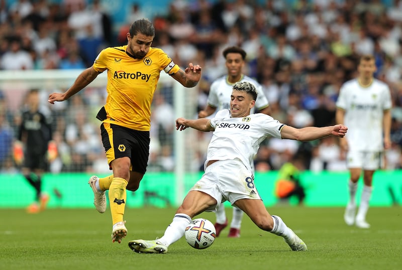 Ruben Neves of Wolverhampton Wanderers is tackled by Marc Roca of Leeds United. Getty