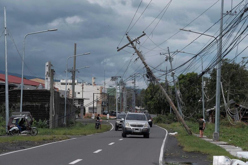 Vehicles pass by toppled electrical poles as Typhoon Kammuri slammed Legazpi city, Albay province, southeast of Manila, Philippines. AP Photo