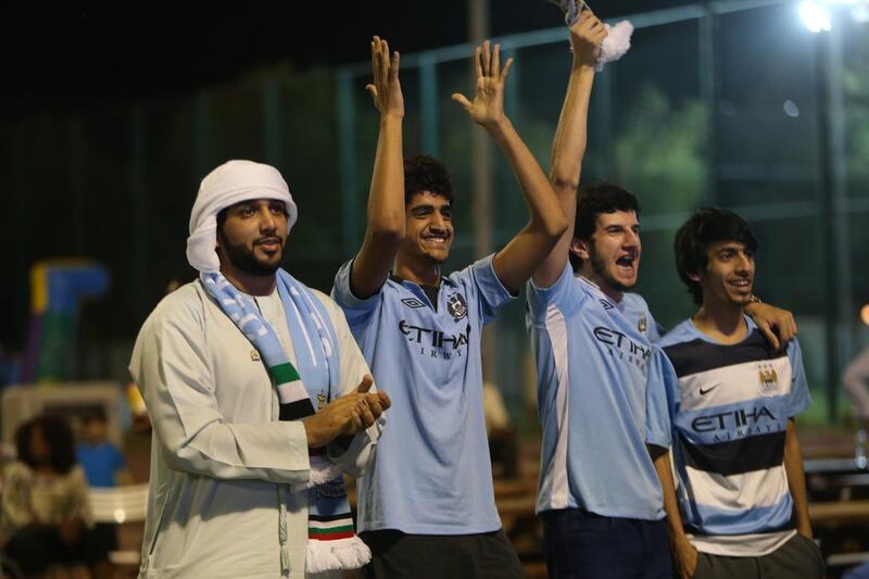 Man City fans celebrate during a free screening of the game against West Ham at Zayed Sports City in Abu Dhabi. Fatima Al Marzooqi / The National