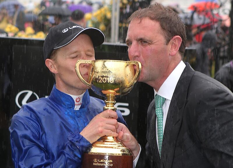 Jockey Kerrin McEvoy and Godolphin trainer Charlie Appleby celebrate after Cross Counter won the annual Melbourne Cup. Associated Press