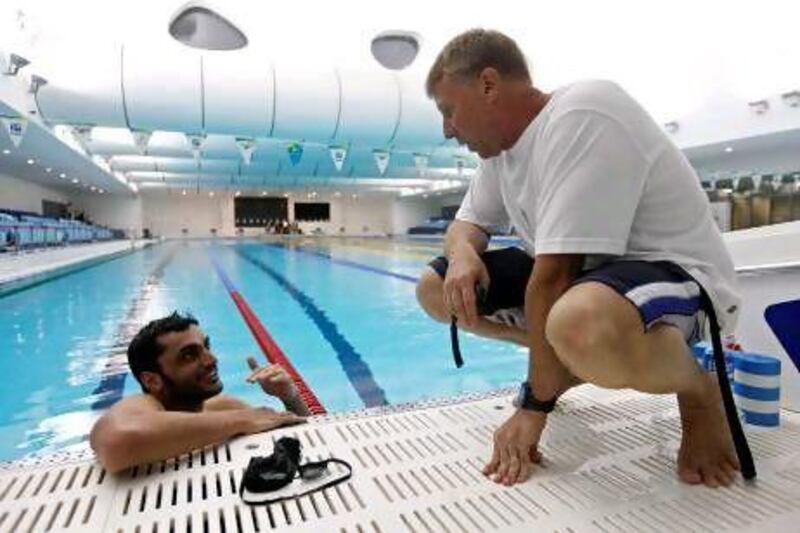 Obaid Al Jasmi, left, talks things over with coach Jay Benner in Hamdan Sports Complex in Dubai during a practice session in early April.