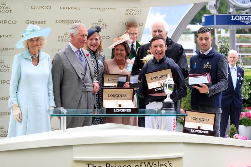 The Duchess of Cornwall, left, and the Prince Charles, second left, present jockey Frankie Dettori and winning connections with the trophy after winning the Prince of Wales's Stakes with Crystal Ocean. Press Association