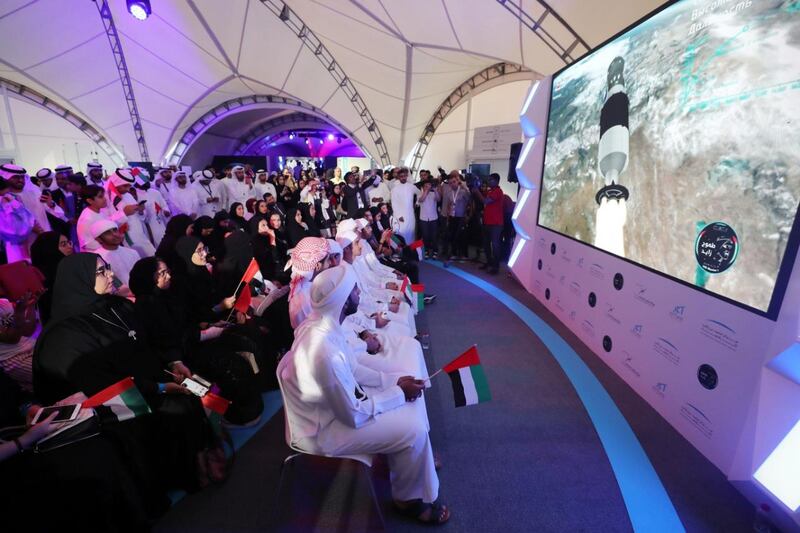 People attend a live screening of the launch of the UAE's first astronaut into space, at Mohammed bin Rashid Space Centre in Dubai. Chris Whiteoak / The National