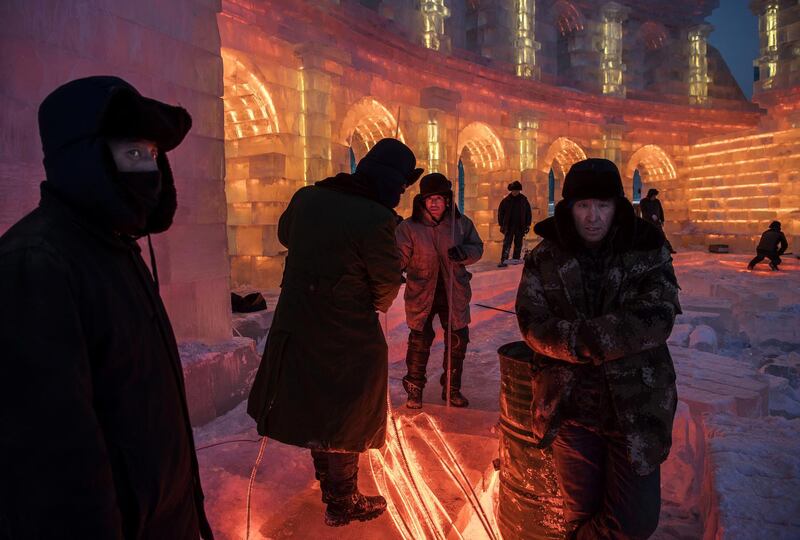 Chinese workers gather lights that will be placed inside ice sculptures in preparation for the Harbin Ice and Snow Festival in Harbin, China. Getty Images