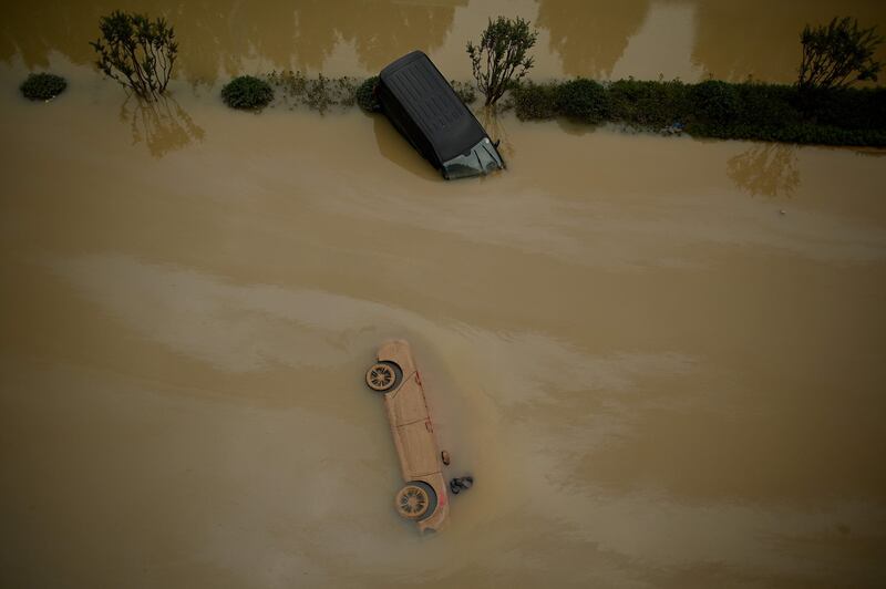 Cars sit in floodwaters following heavy rains, in Zhengzhou in China's central Henan province.