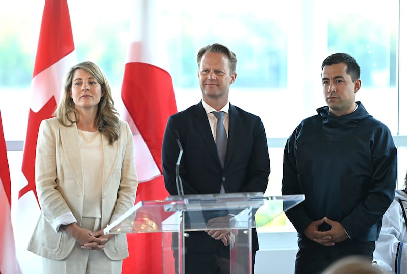 Canadian Foreign Minister Melanie Joly, left, Danish Foreign Minister Jeppe Kofod, centre, and Greenland Prime Minister Mute Bourup Egede after the signing ceremony. AP