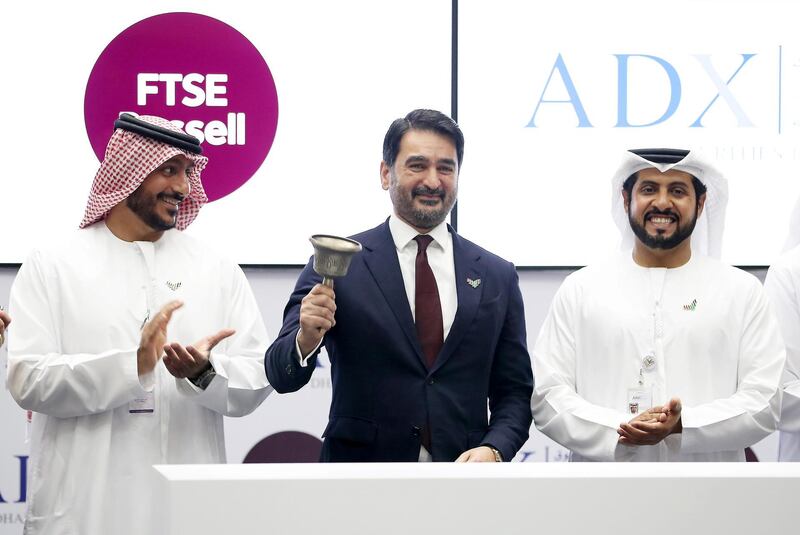 ABU DHABI, UNITED ARAB EMIRATES , Feb 5  – 2020 :- Left to Right - Khalid Bin Shaiban Al Muhairi , Chairman of ADX , Waqas Samad, CEO of FTSE Russell and Khalifa Salem Al Mansouri, Chief Executive of ADX after the signing cooperation agreement ceremony between Abu Dhabi Securities Exchange and FTSE Russell held at Abu Dhabi Securities Exchange trading hall in Abu Dhabi. Waqas Samad, CEO of FTSE Russell ringing the bell. ( Pawan  Singh / The National ) For Business. Story by Fareed