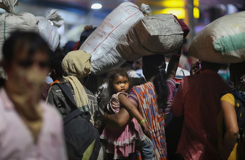 Migrant workers line up to board trains to their home states, at the railway station in Hyderabad, May 23. Mahesh Kumar A / AP