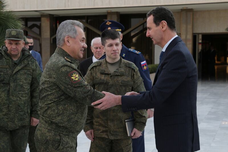 Mr Shoigu, left, is received by Syrian President Bashar Al Assad, right, in Damascus. EPA
