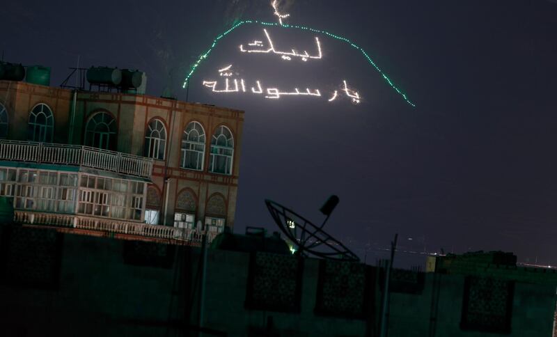 A view of an illuminated phrase reading in Arabic 'The Prophet of God, we are at your orders', written on a mountain overlooking the city ahead of Mawlid celebrations of the birthday of Prophet Muhammad in Sanaa, Yemen.  EPA