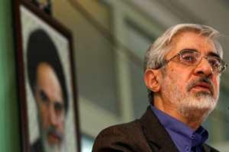 Mir Hossein Mousavi, Iran's former prime minister and candidate for the upcoming presidential elections, delivers a speech under a portrait of late founder of Islamic Republic, Ayatollah Ruhollah Khomeini, during a visit to a mosque in downtown Tehran on March 14, 2009. The reputed moderate who announced earlier this week his candidacy for the June 12 presidential election, said that Tehran's gains in nuclear and space sciences were the result of the Islamic revolution three decades ago.  AFP PHOTO/BEHROUZ MEHRI *** Local Caption ***  Nic347630.jpg