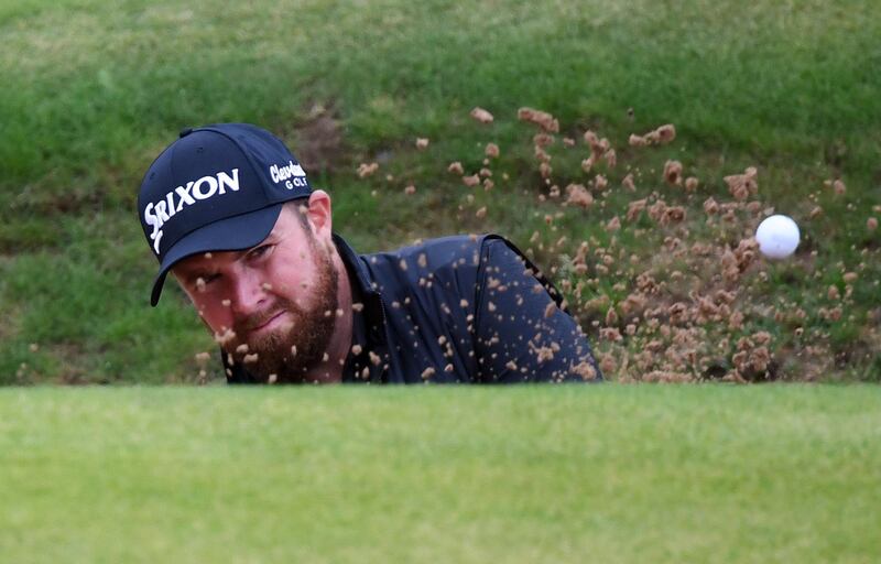 Lowry blasts from a bunker. EPA