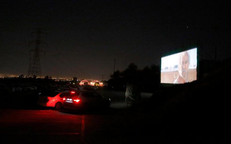 Iranians watch a movie in drive-in cinema at the Milad Tower complex in Tehran, Iran. EPA