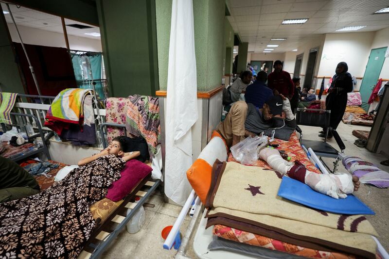 Palestinians injured in Israeli strikes lie on beds at Al Aqsa Martyrs' Hospital in Deir Al Balah. Reuters