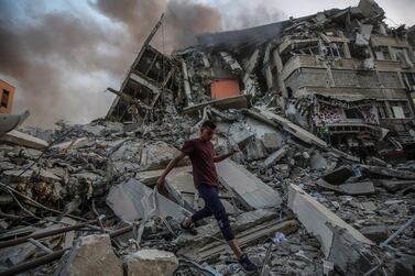A Palestinian man inspects the rubble of the destroyed Al Shorouk tower after an Israeli strike in Gaza city. EPA
