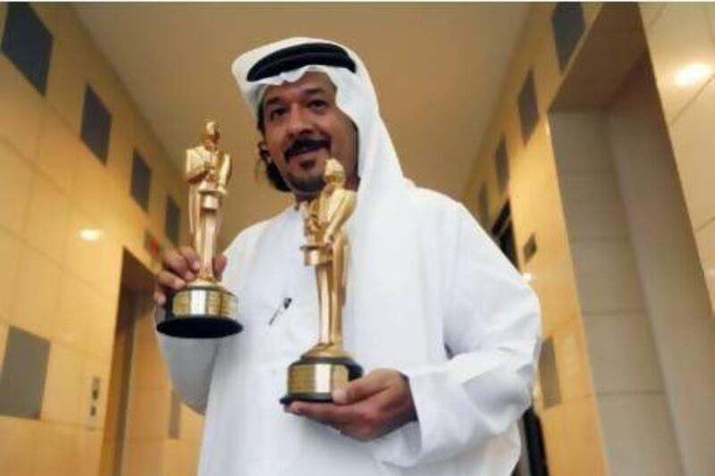 "The Merlin is like the Oscars of magic," says the Emirati magician Muntaser Al Mansouri, with his trophies. Satish Kumar / The National