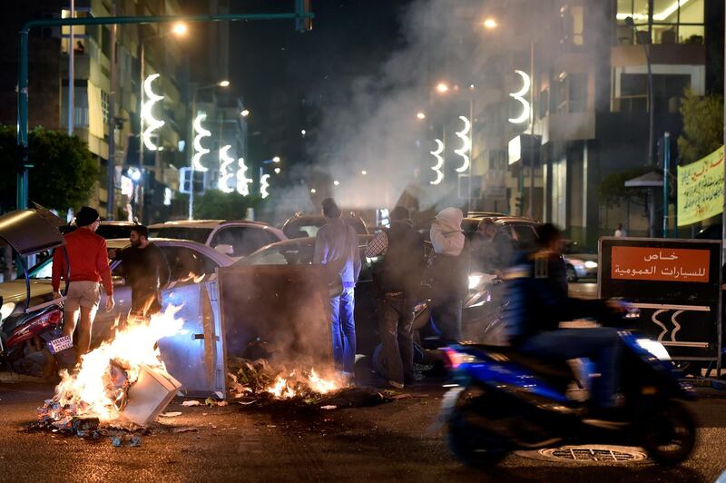 Supporters of outgoing Lebanese Prime Minister Hariri burn dumpsters and woods as they block the main highway to protest against the nomination of Hassan Diab as prime minister.  EPA