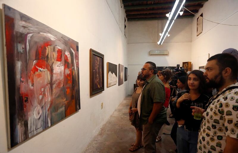 People visit the exhibition 'Insights into Syrian Contemporary Art' in Damascus, Syria. EPA
