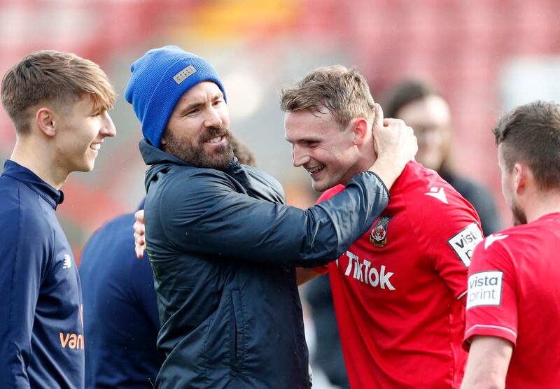 Wrexham co-owners Ryan Reynolds celebrates after winning the match with players. Reuters