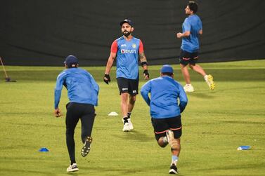 India's Virat Kohli (C) along with teammates warms up during a training session ahead of their first T20 international cricket match of a three-match series against West Indies, at the Eden Gardens in Kolkata on February 14, 2022. (Photo by Dibyangshu SARKAR / AFP) / ----IMAGE RESTRICTED TO EDITORIAL USE - STRICTLY NO COMMERCIAL USE-----