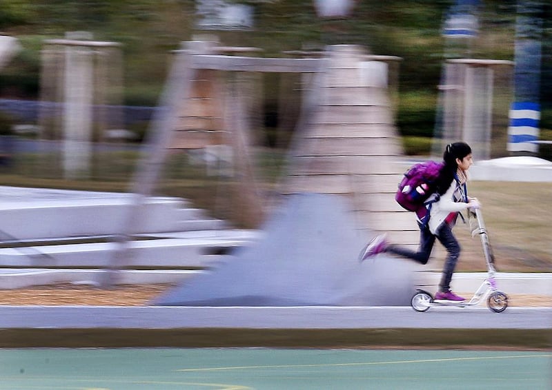 A girl speeds by on her push scooter to school in Frankfurt, Germany. Michael Probst / AP Photo