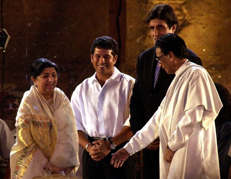 Mangeshkar with Bal Thackeray, founder of the Shiv Sena political party, on March 5, 2001, at a concert held in Mumbai in aid of the Gujarat earthquake victims. Cricketer Sachin Tendulkar and film star Amitabh Bachchan look on. AFP