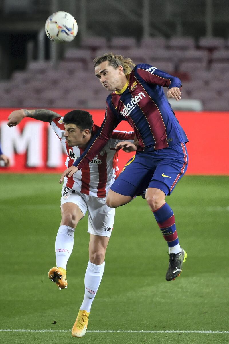 Athletic Bilbao's Spanish defender Ander Capa (L) and Barcelona's French midfielder Antoine Griezmann vie for the ball during the Spanish league football match FC Barcelona against Athletic Club Bilbao at the Camp Nou stadium in Barcelona on January 31, 2021. (Photo by LLUIS GENE / AFP)