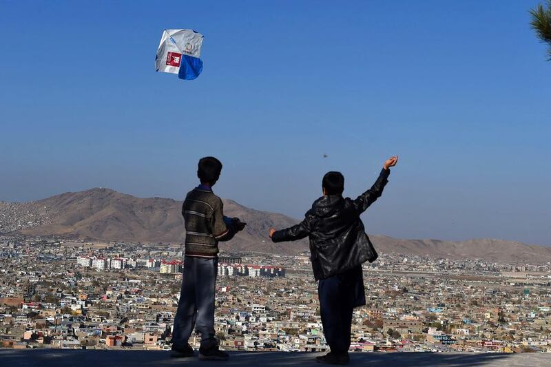 Afghan children fly kites during a kite festival at the Wazir Akbar Khan hilltop in Kabul. The event was held to promote environmental awareness. AFP