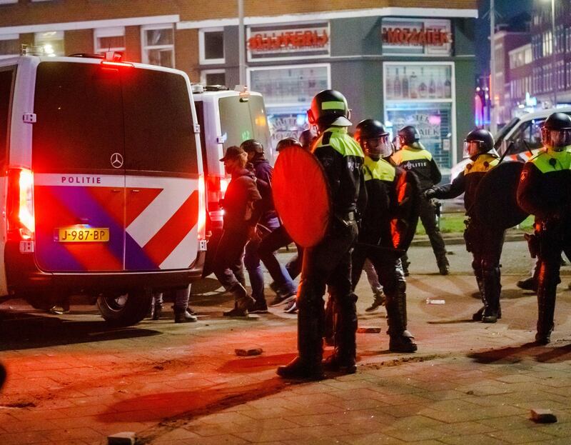Police on the Beijerlandselaan during clashes in Rotterdam. EPA