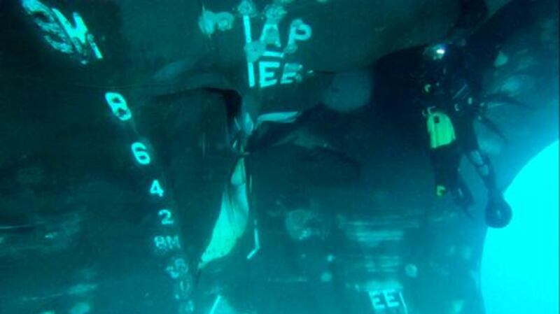 A diver investigates the damage done to oil tanker Al Marzoqah. AP Photo