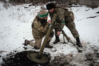 Ukrainian soldiers prepare to fire a mortar towards Russian positions in Bakhmut on Thursday. AFP