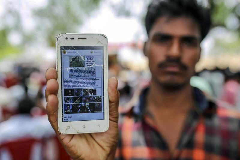 An attendee holds a mobile phone displaying a fake message shared on Facebook Inc.’s WhatsApp messaging service while attending an event to raise awareness on fake news in Balgera village in the district of Gadwal, Telangana, India, on Tuesday, June 12, 2018. At a time when governments around the world are grappling with fake news, police superintendent Rema Rajeshwari's education campaign to stop the spread of bogus social media messages in her district seems to be working. There's been no fake news-related deaths in more than 400 villages under her control in the southern state of Telangana. Photographer: Dhiraj Singh/Bloomberg