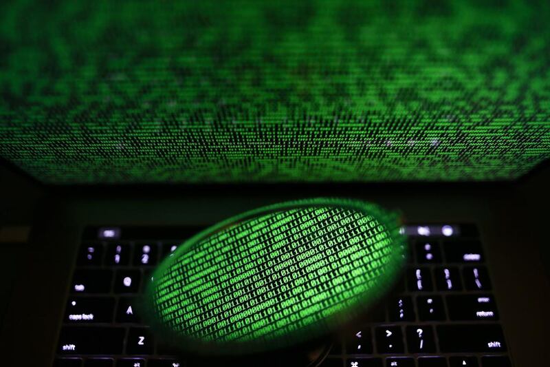 A mirror reflects a computer screen displaying binary code in Taipei, Taiwan. EPA