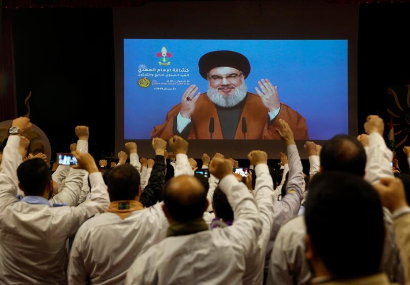Hezbollah scouts raise their fists and cheer as they listen to a speech of Hezbollah leader Sayyed Hassan Nasrallah, via a video link, during an annual anniversary rally for Hezbollah al-Mahdi scouts, in southern Beirut, Lebanon, Monday, April 22, 2019. Nasrallah called the sanctions on Iran the latest sign of U.S. "arrogance" and "aggression", describing them as an attack on the whole world. (AP Photo/Hussein Malla)